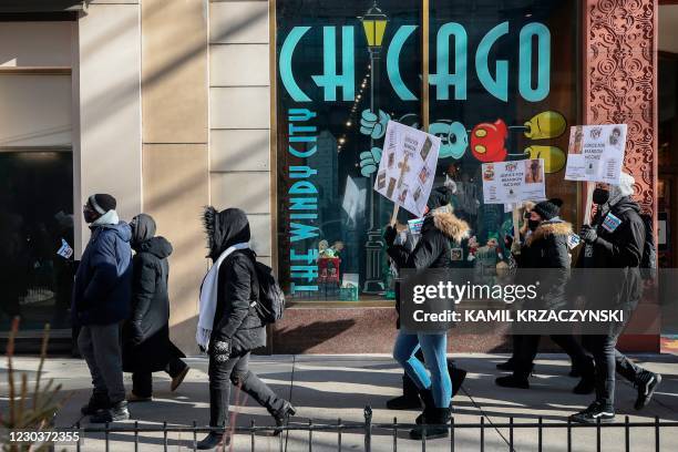 People holding placards, walk during an anti gun violence march on the Magnificent Mile in Chicago, Illinois, on December 31, 2020. - In Chicago,...