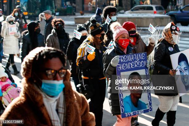 People holding placards, walk during an anti gun violence march on the Magnificent Mile in Chicago, Illinois, on December 31, 2020. - In Chicago,...