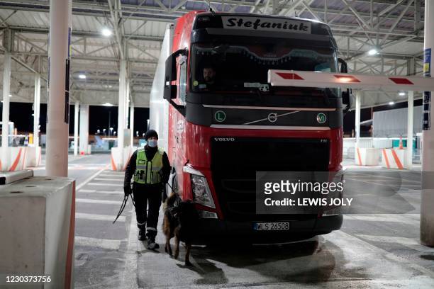 French custom officer checks a lorry at the Eurotunnel terminal on January 1 in Coquelles, northern France. - Britain on Thursday finally severed its...
