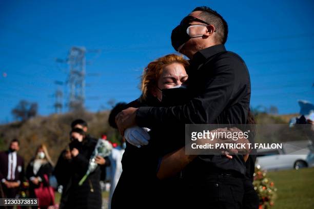 Maricela Arreguin Mejia and her brother Nestor Arreguin mourn the death of their father Gilberto Arreguin Camacho due to Covid-19 during his burial...
