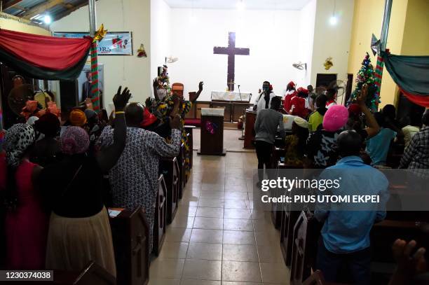 People dance to worship during a crossover night church service at the Anglican Church of Redemption, Diocess of Lagos West, Ibafo in Ogun State...