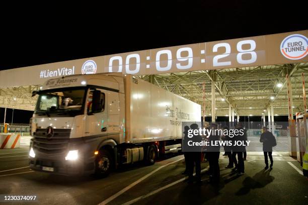 French custom offciers watch the first vehicle entering the Eurotunnel terminal post Brexit, an Estonian lorry driver, on January 1 in Coquelles,...