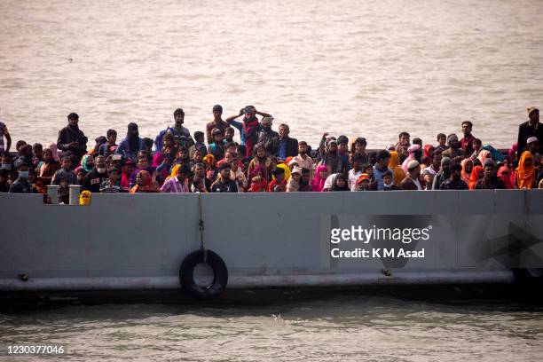 Rohingya refugees on a Bangladesh navy vessel first look at the land before arrived to the Bhasan Char island in Noakhali district, Bangladesh.