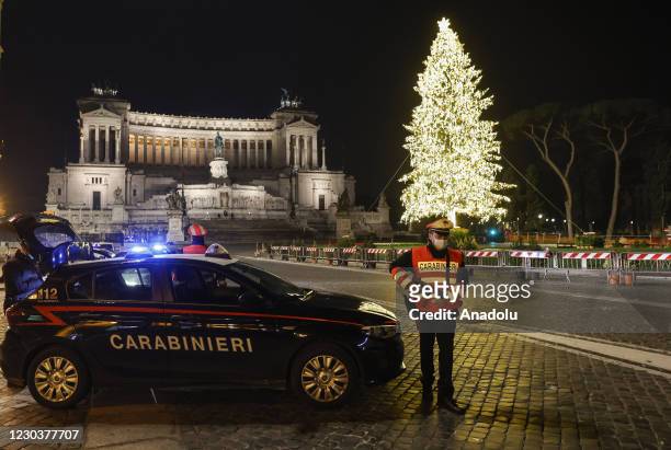 Carabinieri officers patrol a desert Piazza Venezia two hours before the midnight marking the transition to the new year in Rome, Italy, on December...