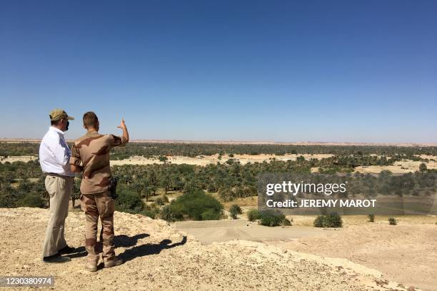 French Prime Minister Jean Castex listens to a French soldiers in Faya Largeau, Chad, on December 31 after spending the New Year's Eve with French...