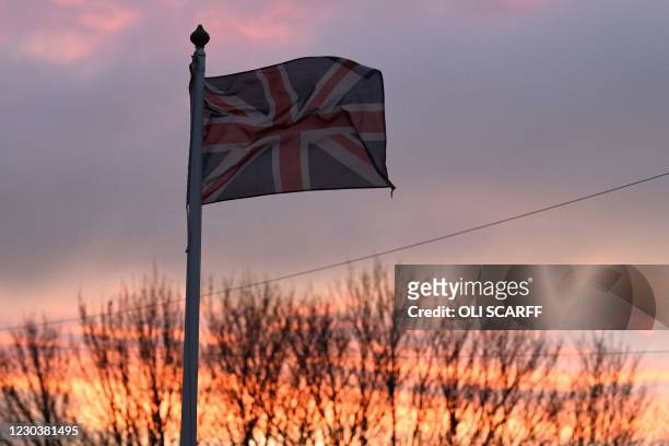 Union flag flutters in the breeze as the sun sets in Hartlepool, north-east England, on January 1 where 69.6% of voters in the 2016 "Brexit"...