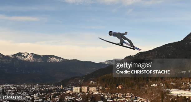 Switzerland's Dominik Peter soars through the air during the first competition jump on the second event of the Four-Hills Ski Jumping tournament in...