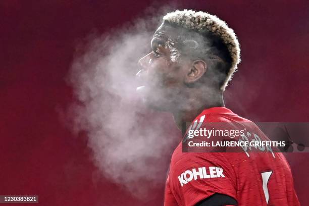 Manchester United's French midfielder Paul Pogba in a cloud of his own breath during the English Premier League football match between Manchester...