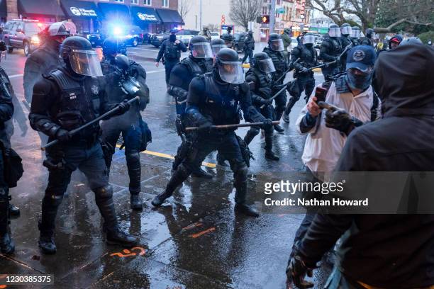 Salem Police disperse members of the far-right during a protest against COVID-19 restrictions on January 1, 2021 in Salem, Oregon. Police declared...