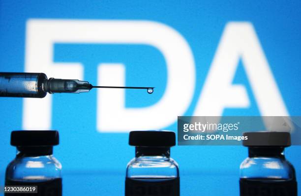 In this photo illustration a medical syringe and vials are seen in front of the Food and Drug Administration logo. The World Health Organization on...