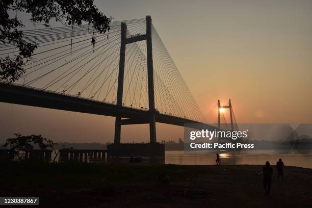 The rising sun through the Vidyasagar Setu across the Ganges on the first day of Gregorian calendar year 2021.