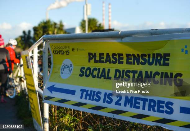 'Please Ensure Social Distancing' banner displayed at the entrance to Sandymount Strand in Dublin, on New Year's Day, during the Covid-19 level 5...