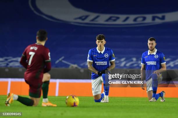 Brighton's English defender Ben White takes a knee against racism before kick off of the English Premier League football match between Brighton and...