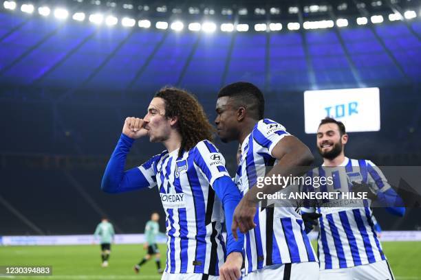 Hertha Berlin's French midfielder Mattéo Guendouzi celebrates scoring the opening goal with teammates during the German first division Bundesliga...