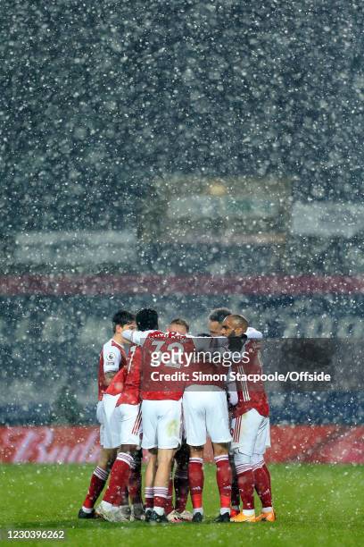 Arsenal celebrate their first goal scored by Kieran Tierney in the snow during the Premier League match between West Bromwich Albion and Arsenal at...