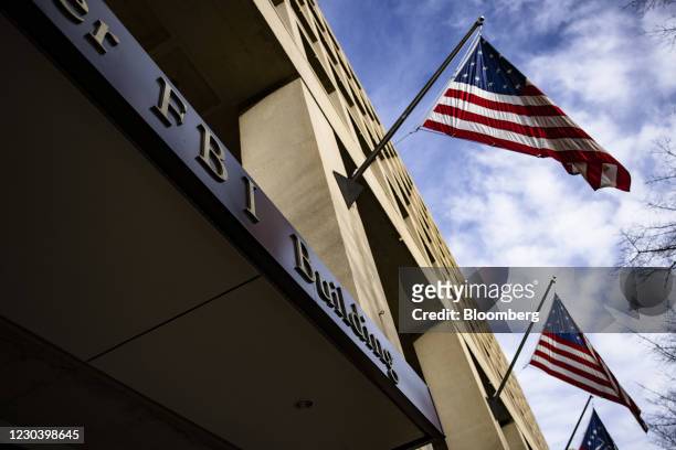 American flags fly outside the Federal Bureau of Investigation headquarters in Washington, D.C., U.S., on Saturday, Jan. 2, 2021. A group of 11...