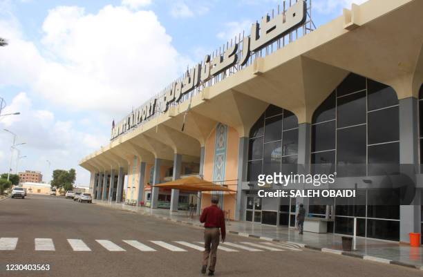 Man walks to the airport building in Yemen's southern city of Aden on January 3 as activity resumes after explosions rocked the building on December...