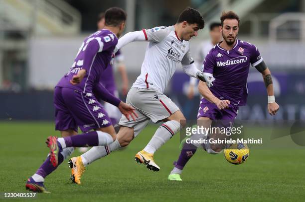 Gaetano Castrovilli of ACF Fiorentina battles for the ball with Riccardo Orsolini of Bologna FC during the Serie A match between ACF Fiorentina and...