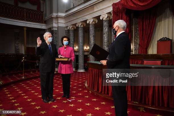 Senate Majority Leader Mitch McConnell participates in a mock swearing-in for the 117th Congress with Vice President Mike Pence, as his wife...