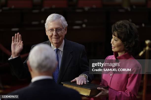 Senate Majority Leader Mitch McConnell, R-KY, participates in a mock swearing-in for the 117th Congress with Vice President Mike Pence, as his wife...