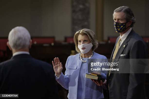 Senator Shelley Moore Capito, Republican from West Virginia, center, wears a protective mask while being ceremoniously sworn-in by U.S. Vice...