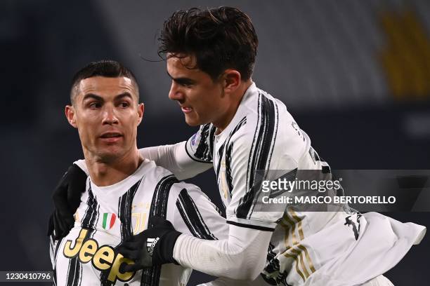 Juventus' Portuguese forward Cristiano Ronaldo celebrates with Juventus' Argentine forward Paulo Dybala after opening the scoring during the Italian...