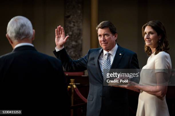 Vice President Mike Pence administers the Senate oath of office to Bill Hagerty as his wife Chrissy, holds the bible, during a mock swearing-in...