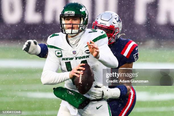 Sam Darnold of the New York Jets is tackled as he throws the football during a game against the New England Patriots at Gillette Stadium on January...