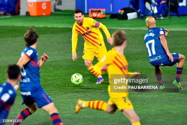 Barcelona's Argentinian forward Lionel Messi runs with the ball during the Spanish League football match between Huesca and Barcelona at the El...