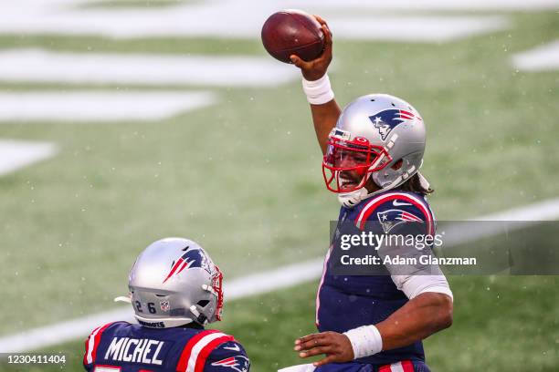 Sony Michel reacts with Cam Newton of the New England Patriots after scoring a touchdown during a game against the New York Jets at Gillette Stadium...