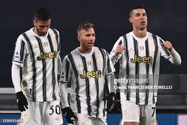 Juventus' Portuguese forward Cristiano Ronaldo celebrates with Juventus' Uruguayan midfielder Rodrigo Bentancur and Juventus' Brazilian midfielder...