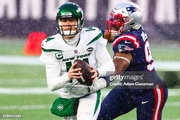 Sam Darnold of the New York Jets is tackled as he throws the football during a game against the New England Patriots at Gillette Stadium on January...