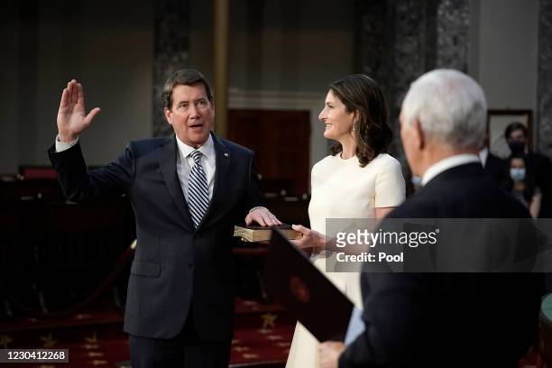Sen. Bill Hagerty joined by his wife Chrissy Hagerty, takes the oath of office from Vice President Mike Pence during a mock swearing-in ceremony in...