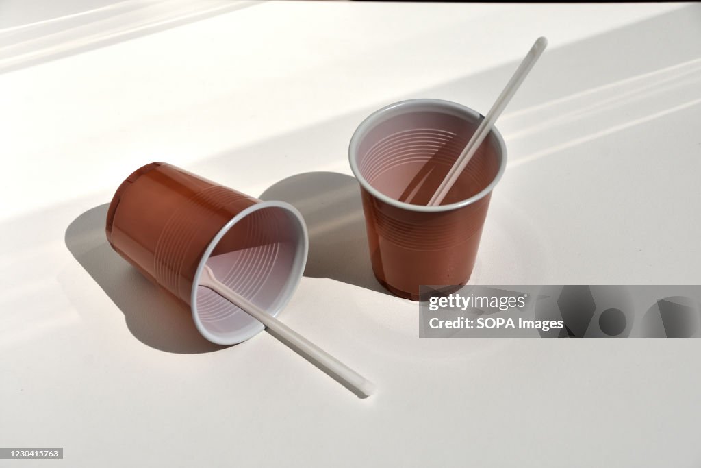 In this photo illustration plastic coffee stirrers in brown...