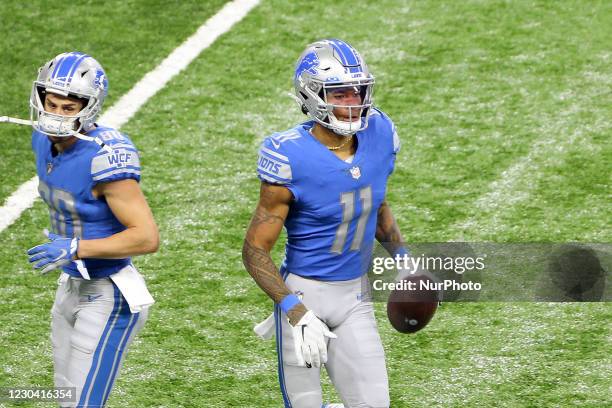 Detroit Lions wide receiver Marvin Jones runs off the field after making a touchdown during the first half of an NFL football game between the...