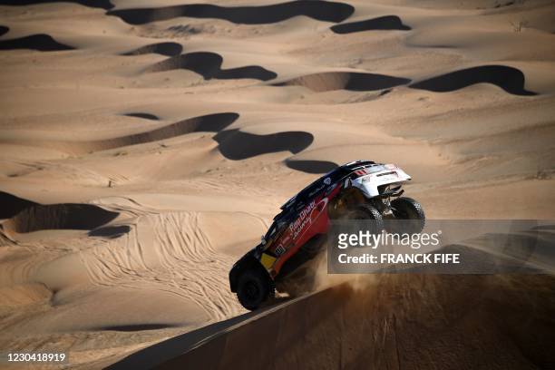 Peugeot's driver Khalid Sheikh al-Qassimi of Saudi Arabia and co-driver French Xavier Panseri compete during Stage 2 of the Dakar Rally 2021 between...