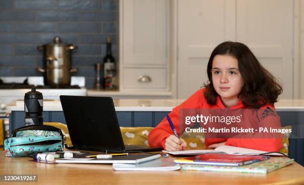 Sophie Symes, a year 7 pupil at Knutsford Academy in Cheshire, studies at home as many schools switch to online learning.