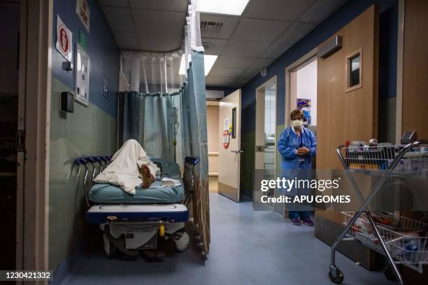 Patient rests in a corridor waiting for a room at Providence Cedars-Sinai Tarzana Medical Center in Tarzana, California on January 3, 2021. -...