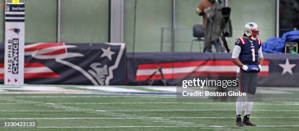 Sign on the goalpost in the background reads "Inspire Change" as Patriots quarterback Cam Newton is pictured in the first quarter. It has been...