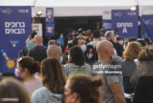 People queue outside a Covid-19 mass vaccination center at Rabin Sqaure in Tel Aviv, Israel, on Monday, Jan. 4, 2020. Israel plans to vaccinate 70%...