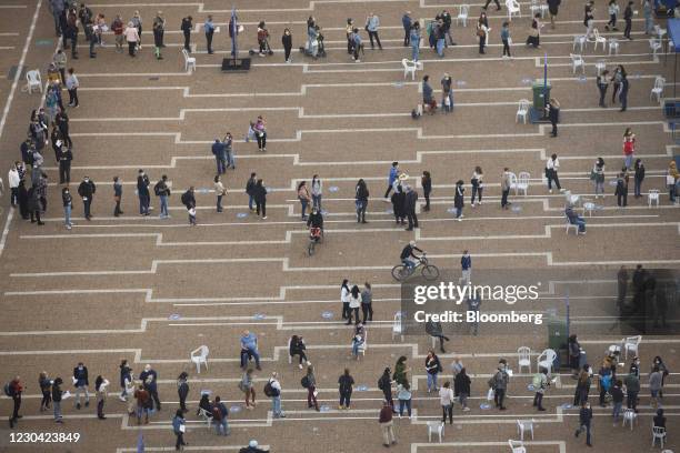 People queue outside a Covid-19 mass vaccination center at Rabin Sqaure in this aerial photograph taken in Tel Aviv, Israel, on Monday, Jan. 4, 2020....