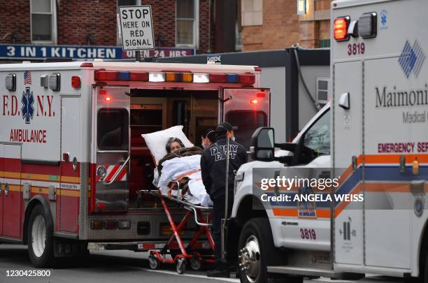 Healthcare workers transport a patient from an ambulance to Maimonides Medical Center, a hospital in the Brooklyn neighborhood of Borough Park, on...