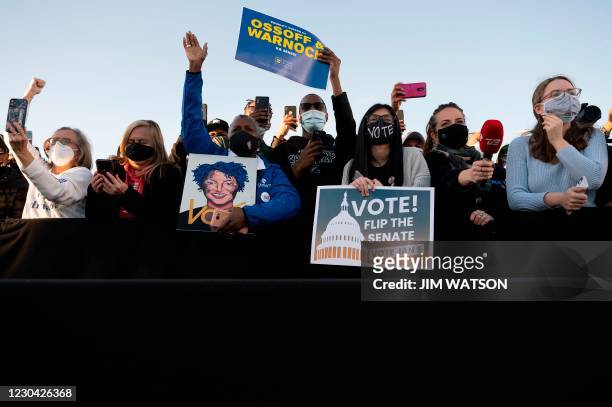 Supporters of democratic candidates for Senate Jon Ossoff and Raphael Warnock (listen to US President-elect Joe Biden speak during a rally outside...