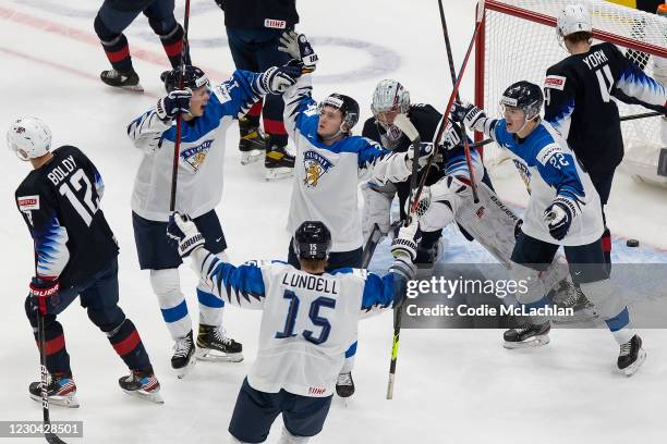 Kasper Puutio, Kasper Simontaival, Roni Hirvonen and Anton Lundell of Finland celebrate a goal against goaltender Spencer Knight of the United States...