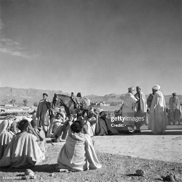 An indigenous affairs officer vaccinates Berber people against typhus, which made its appearance in the Haut-Ziz region, in December 1945, in...