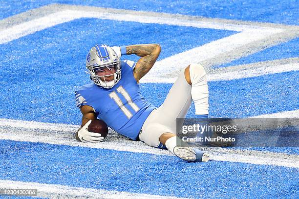 Detroit Lions wide receiver Marvin Jones poses after bringing the ball into the end zone during the second half of an NFL football game between the...