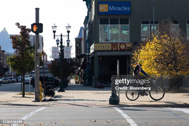 Cyclist rides a bike through downtown Pontiac, Michigan, U.S., on Saturday, Oct. 31, 2020. Michigan surpassed half a million confirmed cases of the...