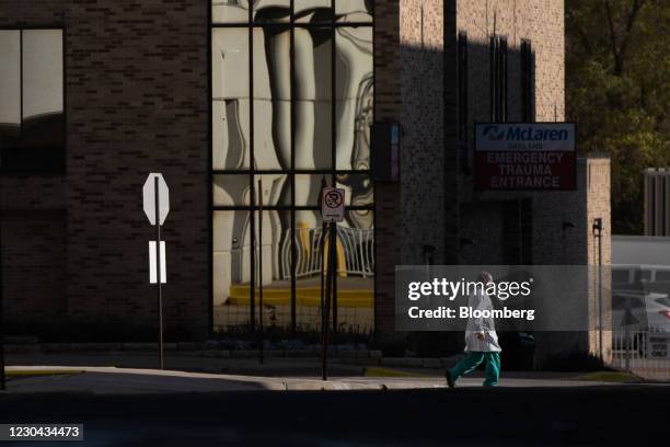 Healthcare worker walks by the McLaren Emergency Room entrance in downtown Pontiac, Michigan, U.S., on Saturday, Oct. 31, 2020. Michigan surpassed...