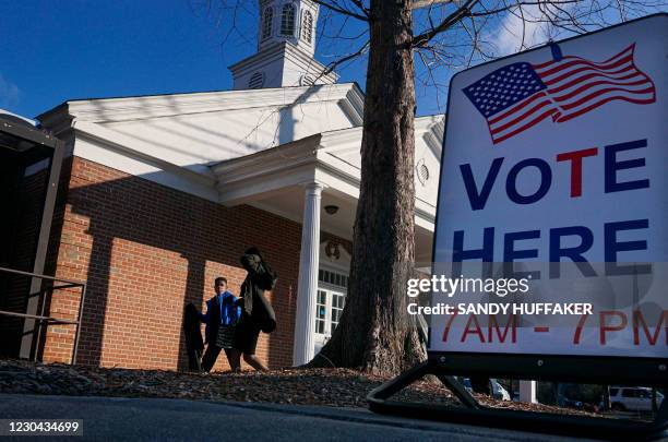 Voters enter a polling station at the Zion Baptist Church on January 5, 2021 in Marietta, Georgia. After an unprecedented campaign that mobilized...