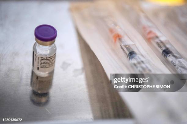 Picture shows a vial containing the Pfizer-BioNTech Covid-19 vaccine next to syringes at the Timone Hospital in Marseille, southeastern France, on...